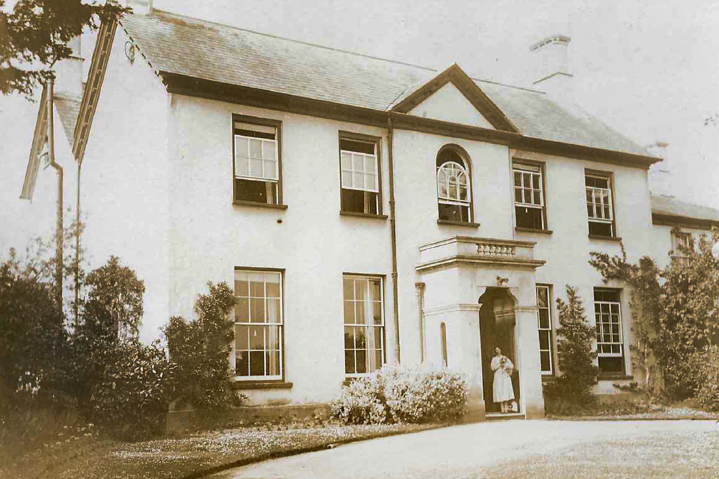 Alcombe Lodge now demolished with Mrs Hancock in the doorway